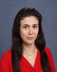 A woman with long dark hair and a red shirt