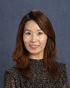 A woman with long dark hair and dark shirt