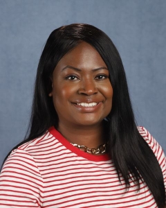 A woman with long dark hair and a red and white striped shirt